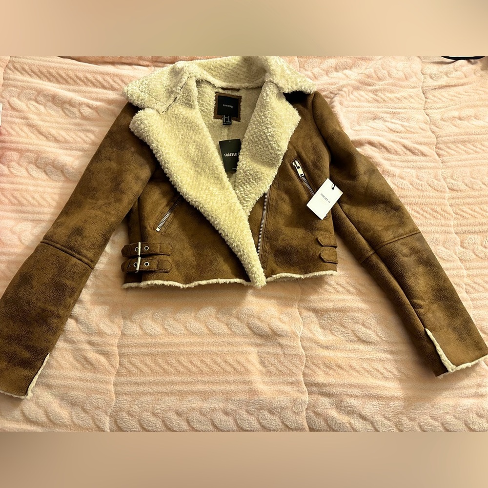 Brand new. Never worn with tags. Warm jacket. Women’s size small. Forever 21.